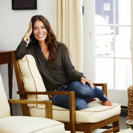 Laura Wasser, founder of It's Over Easy pictured sitting in a living room.
