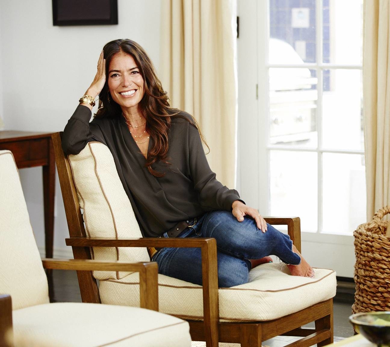 Laura Wasser, founder of It's Over Easy pictured sitting in a living room.